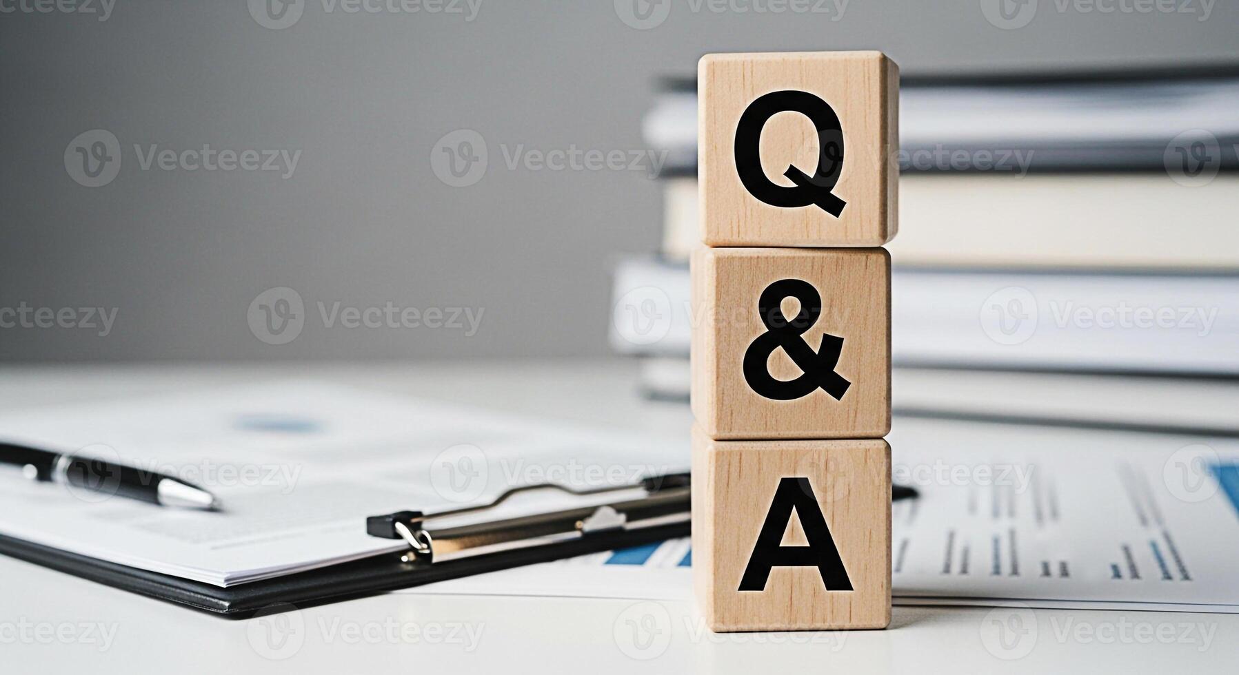 Wooden blocks displaying Q A on a white desk with documents and a pen representing a question and answer session in a professional and informative business environment fostering clarity and understand photo