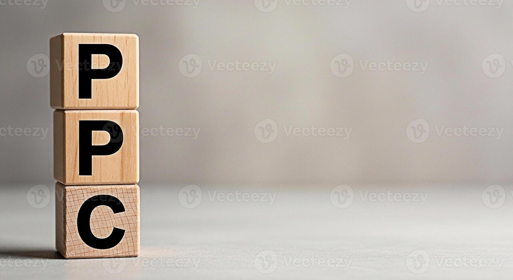 Wooden blocks displaying PPC in a neutral setting representing payperclick advertising and online marketing strategies for business growth and success in the digital age conveying a message of efficie photo
