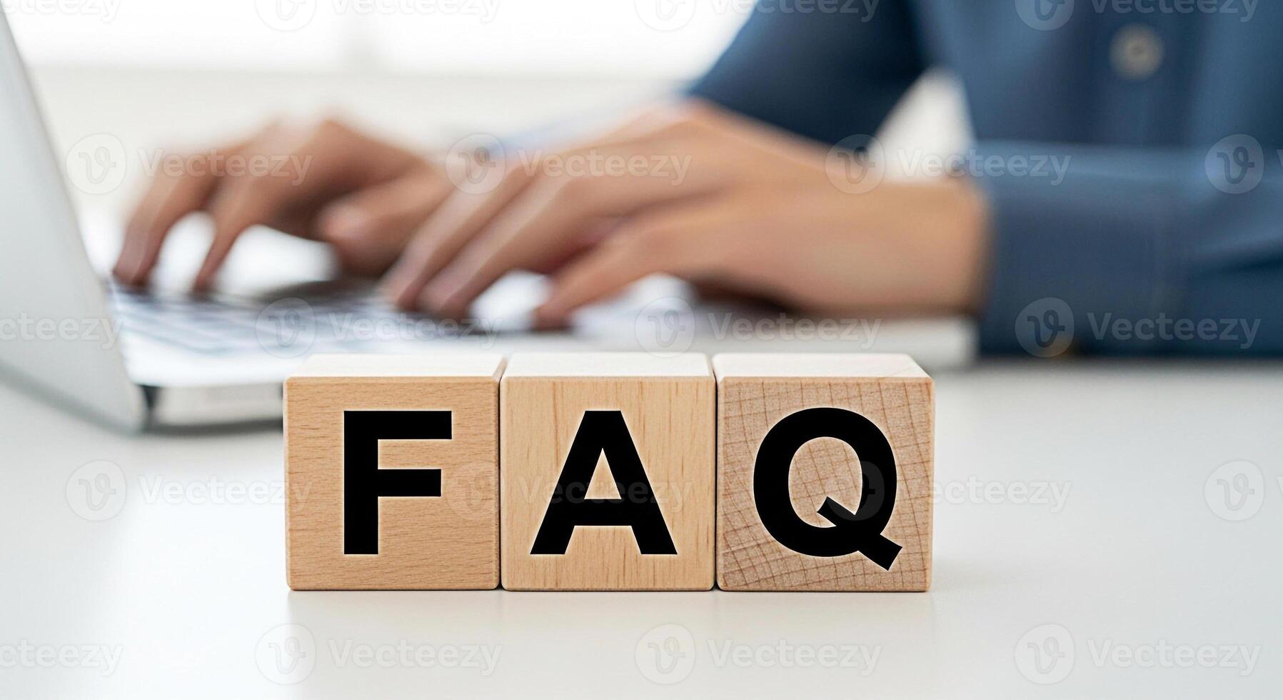 Customer service representative answering questions on a laptop with FAQ blocks on a white desk conveying support and assistance for online help and information creating a helpful and informative atmo photo