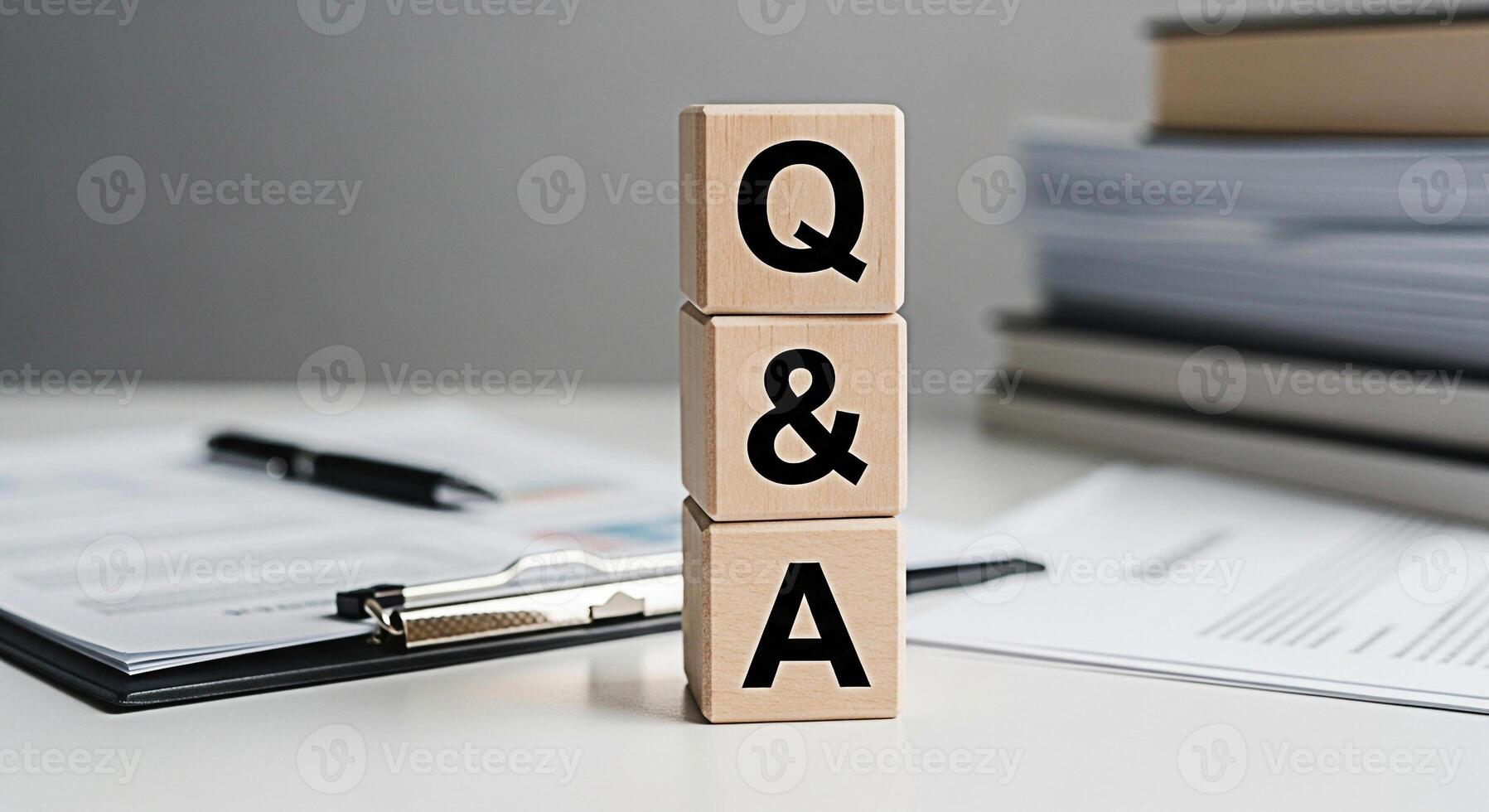 Wooden blocks displaying QA on a bright desk symbolizing knowledge and solutions in a professional setting promoting clarity and understanding for business and educational purposes photo