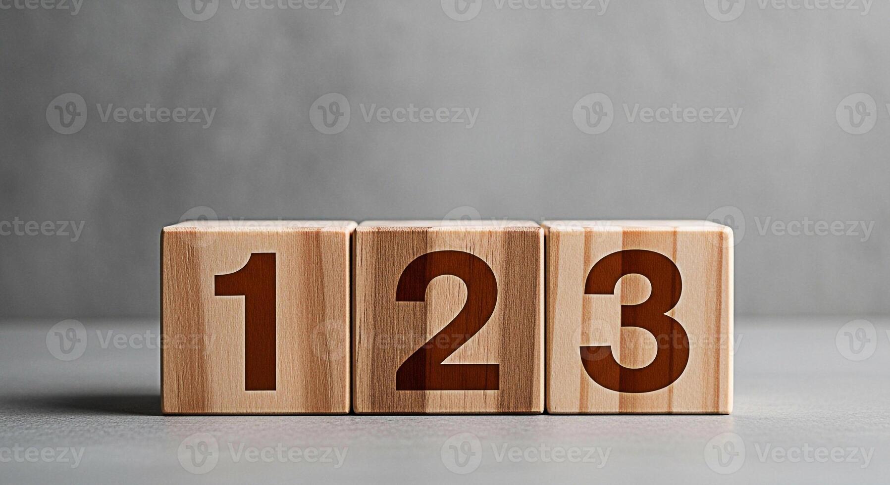 Wooden blocks displaying numbers one two and three on a gray surface symbolizing sequence learning and counting in an educational and minimalist setting conveying simplicity and order photo
