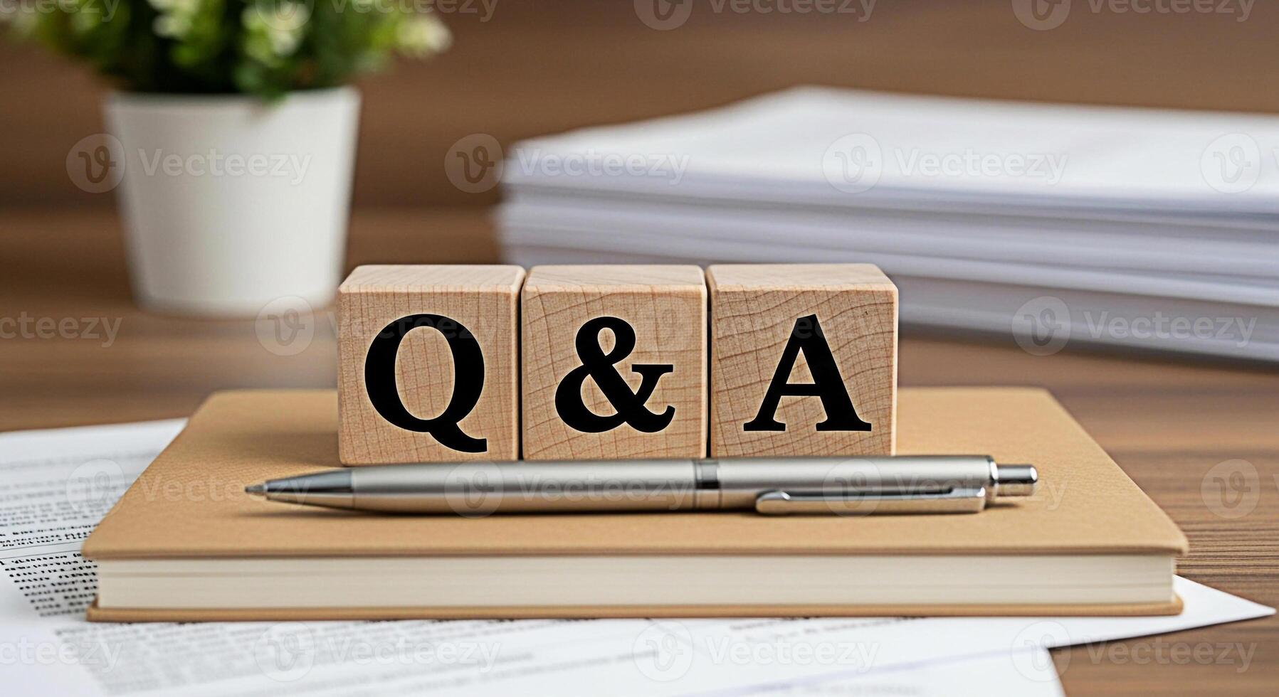 Wooden blocks displaying Q A on a notebook with a pen symbolizing questions and answers in a learning environment fostering a mood of understanding and knowledge acquisition on a wooden desk photo