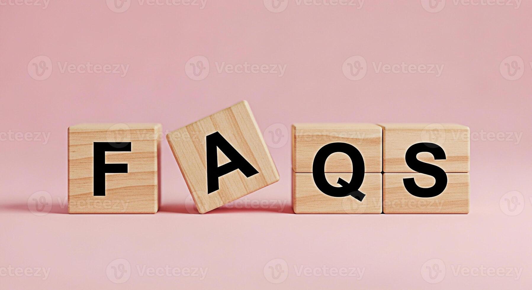 Wooden blocks spelling FAQs on a pink background representing frequently asked questions and information creating a helpful and informative mood for customer service and support resources photo