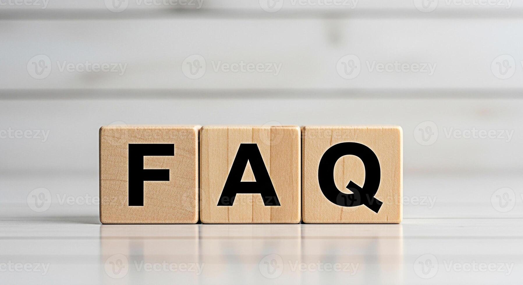 Wooden blocks displaying FAQ on a white wooden surface representing frequently asked questions and information creating a clear and informative atmosphere for customer support and online assistance photo