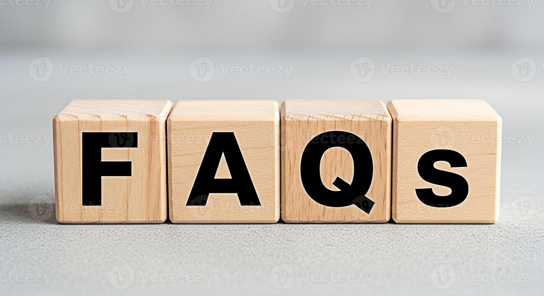 Wooden blocks displaying FAQs on a neutral surface representing information access and customer support creating a sense of clarity and guidance for users seeking answers to common questions photo