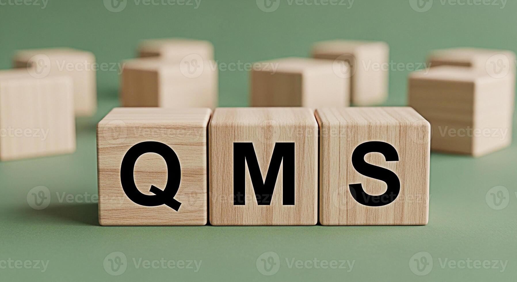 Wooden blocks displaying QMS on a green surface representing quality management system implementation and adherence to standards in a business environment conveying a sense of order and compliance photo