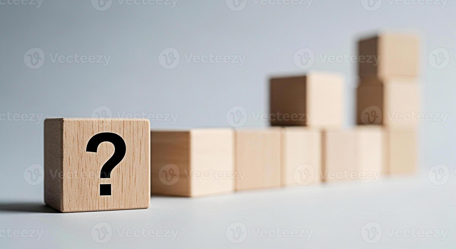 Wooden block displaying a question mark symbol in a minimalist setting representing uncertainty and the search for answers leading to growth and success in a business context fostering curiosity photo