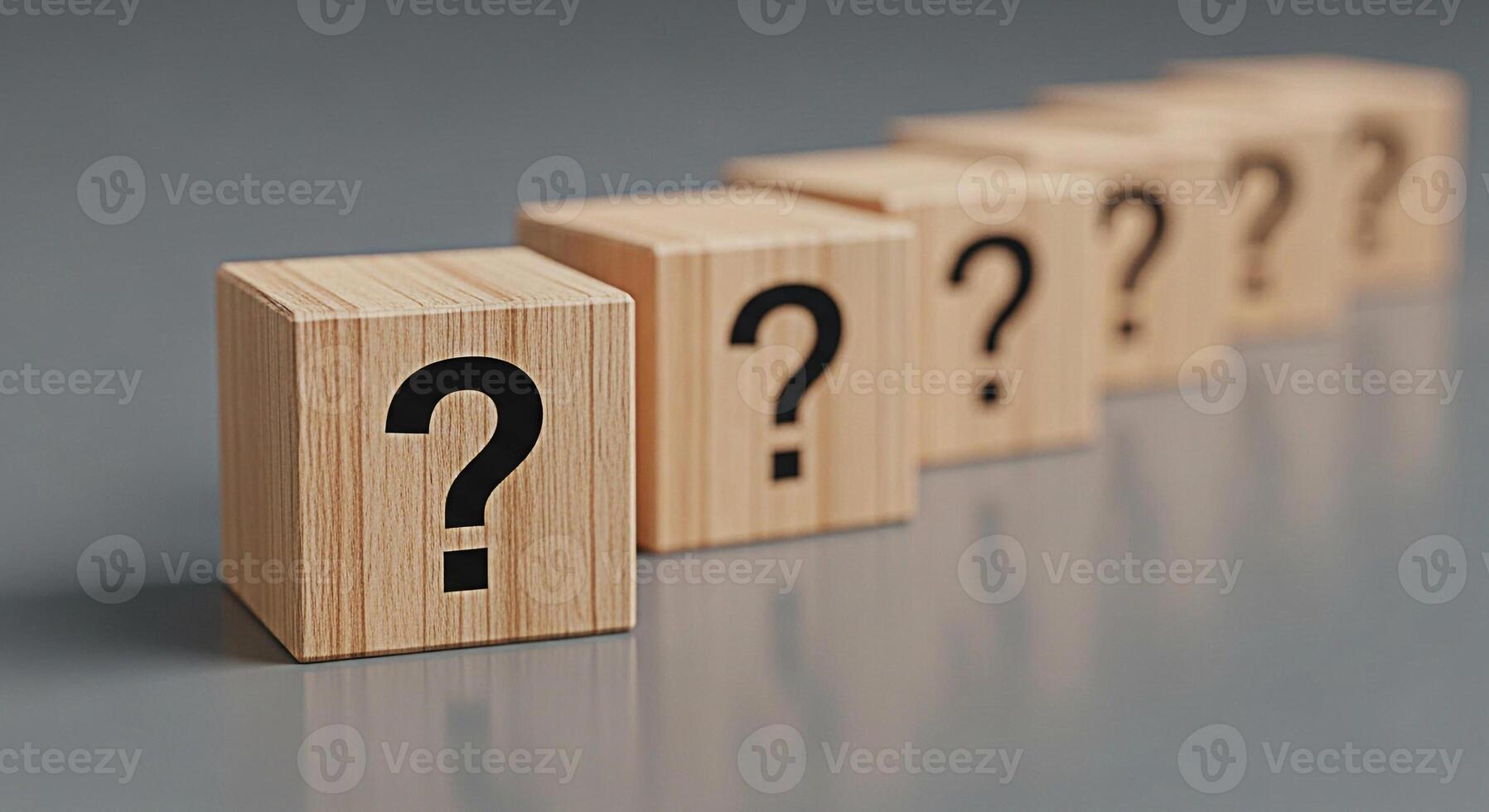 Wooden blocks displaying question marks in a row on a gray surface symbolizing uncertainty and the need for answers creating a mood of inquiry and problemsolving photo