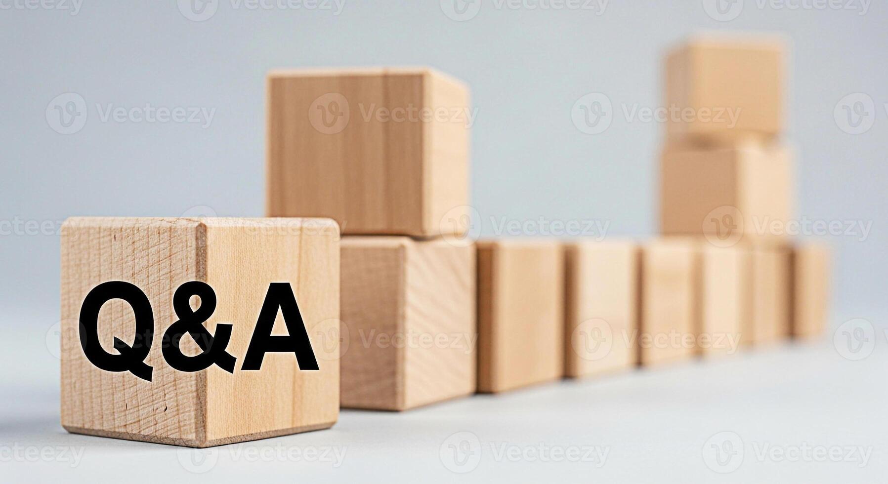 Wooden blocks displaying QA in a bright studio setting representing knowledge learning and problemsolving with a focus on questions and answers for educational and business concepts photo