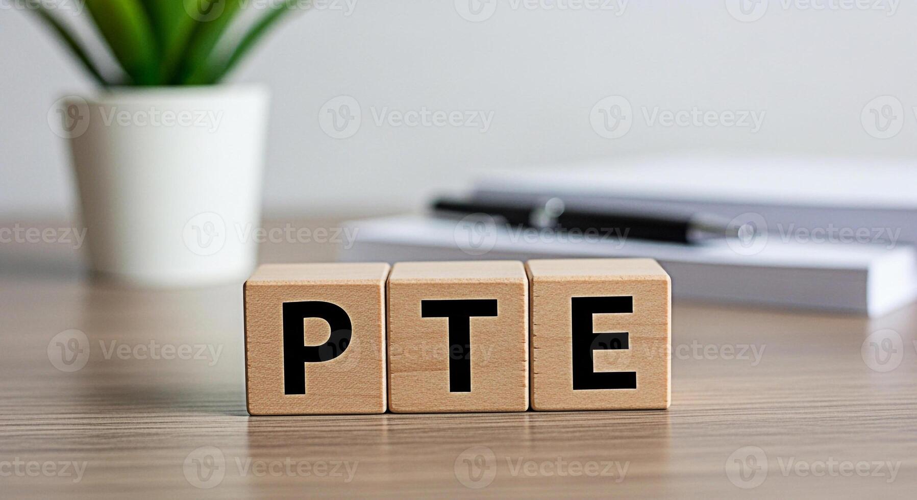 PTE exam preparation concept with wooden blocks displaying PTE letters on a desk representing English language proficiency test readiness and a focused learning environment for academic success photo