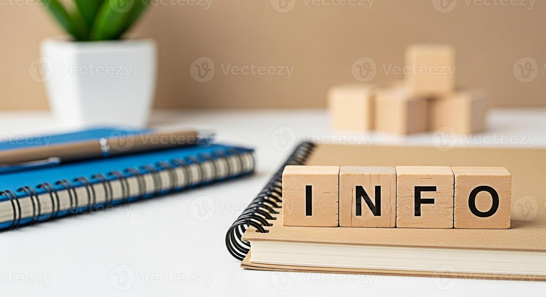 Wooden blocks spelling INFO resting on a notebook in a bright modern office setting symbolizing knowledge information access and educational resources for business and personal development photo