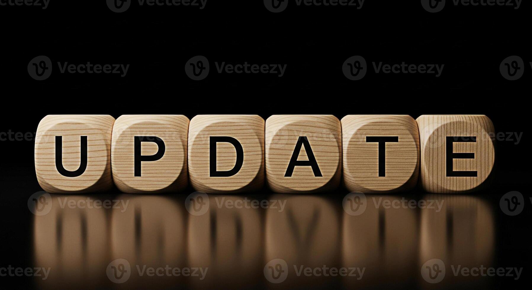 Wooden blocks spelling UPDATE on a reflective black surface conveying a sense of progress and modernization symbolizing software updates system upgrades and the importance of staying current in a digi photo