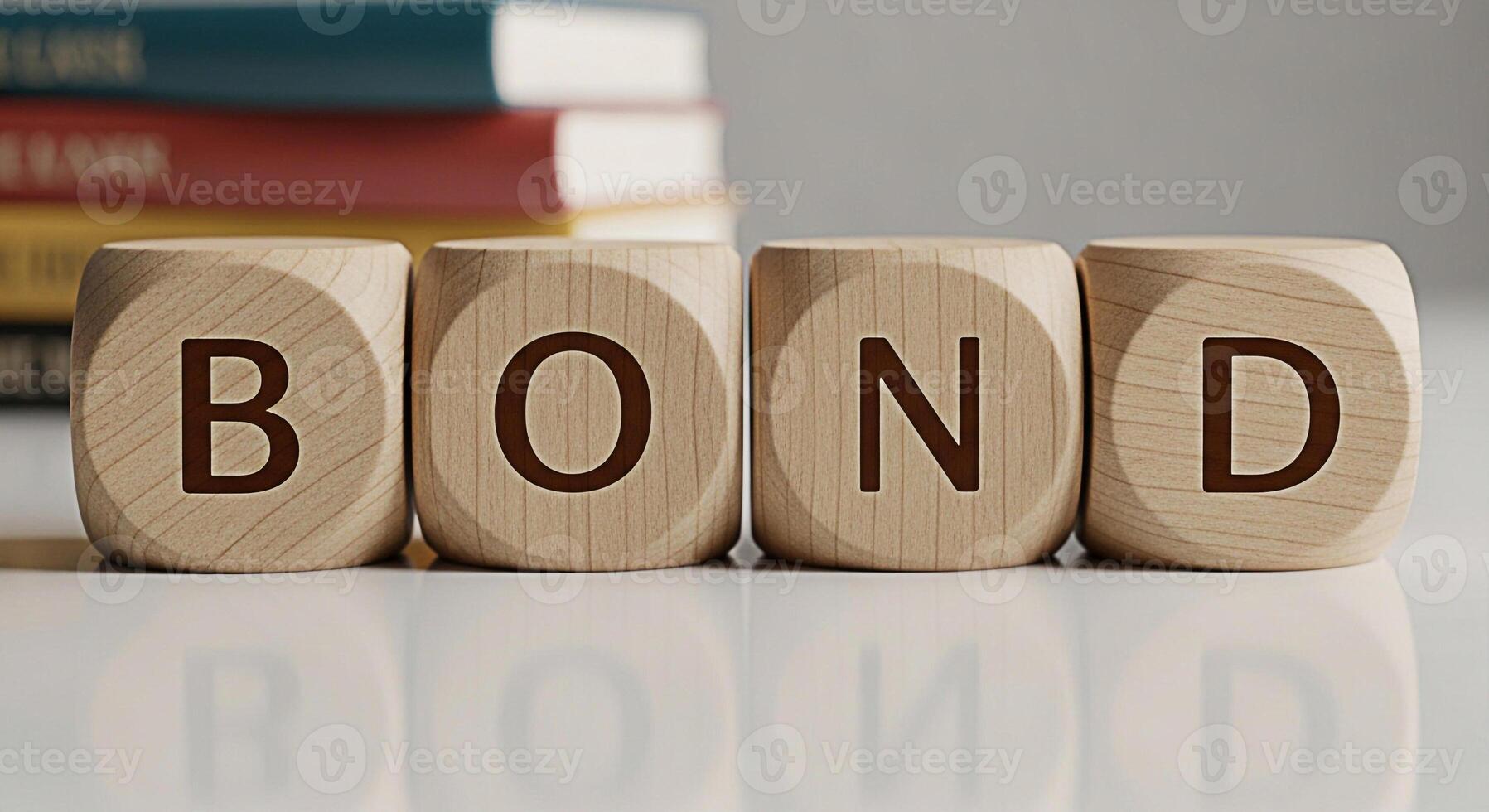Wooden blocks spelling out BOND on a reflective surface in a bright studio setting representing financial security and investment opportunities for the future with books in the background photo