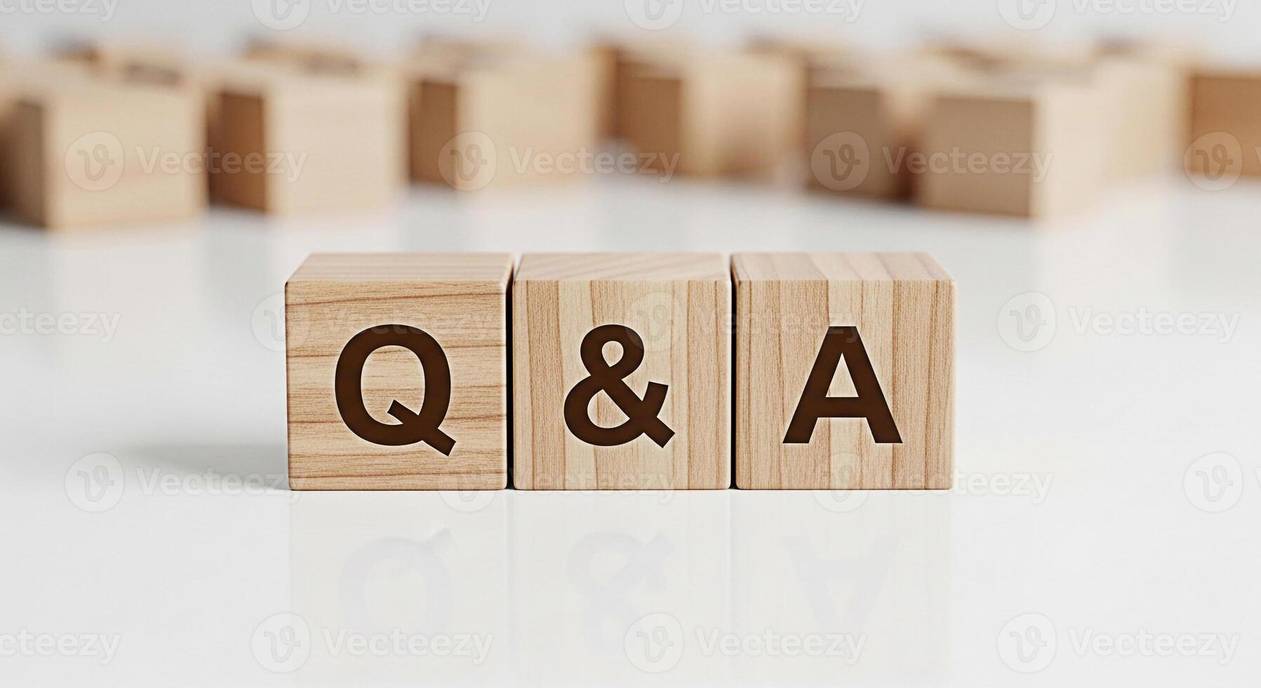 Wooden blocks displaying Q A on a white reflective surface representing questions and answers in a clean and minimalist setting conveying clarity and information for business or educational purposes photo