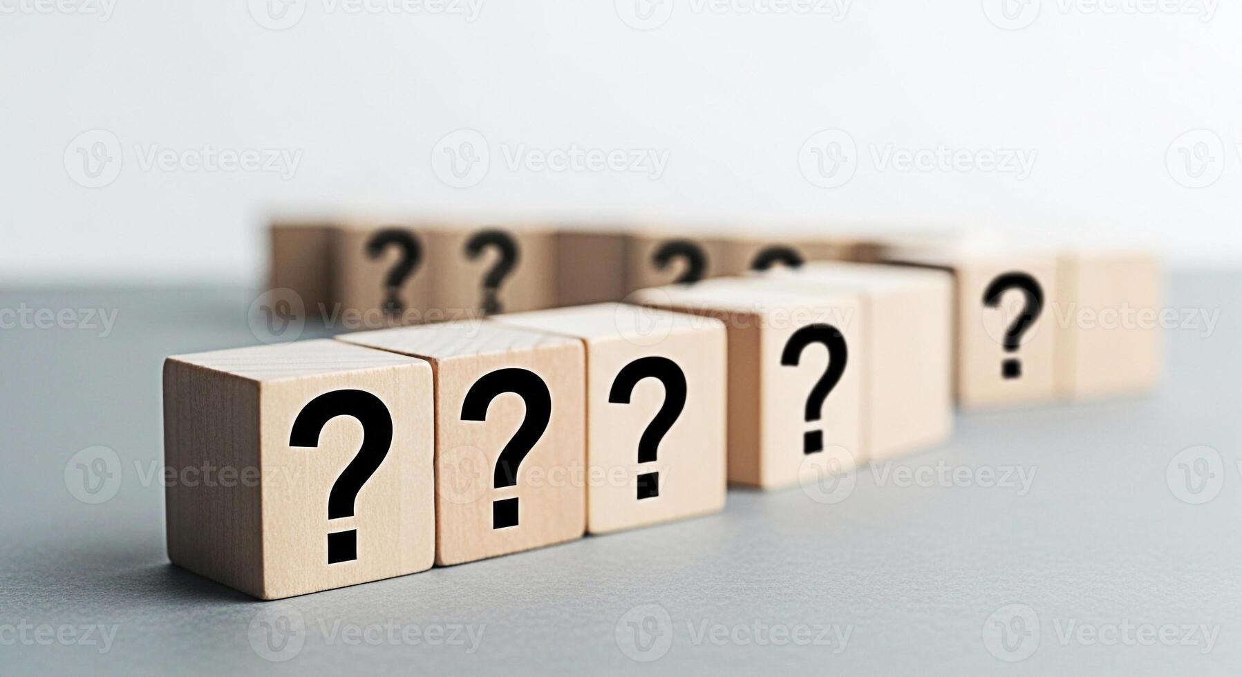Wooden blocks displaying question marks in a row on a gray surface representing uncertainty and the search for answers in a minimalist and thoughtprovoking composition symbolizing problemsolving photo