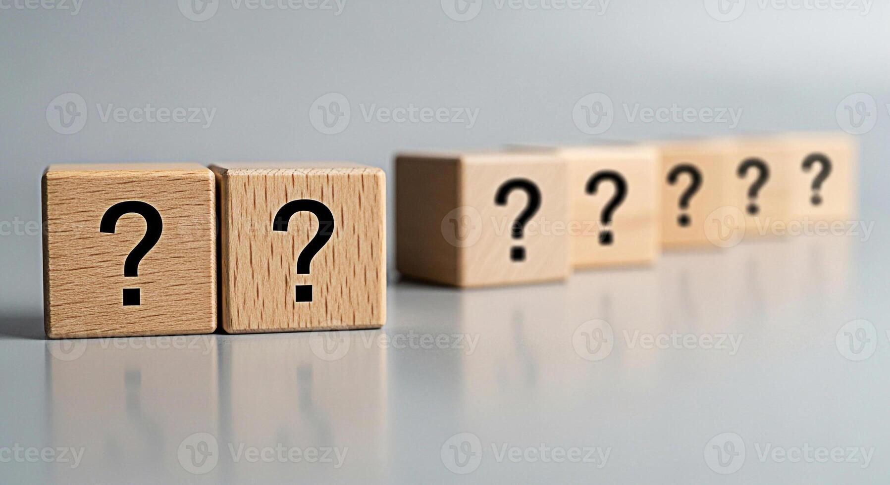 Wooden blocks displaying question marks on a reflective surface symbolizing uncertainty and the search for answers in a conceptual and thoughtprovoking manner perfect for educational or business conte photo
