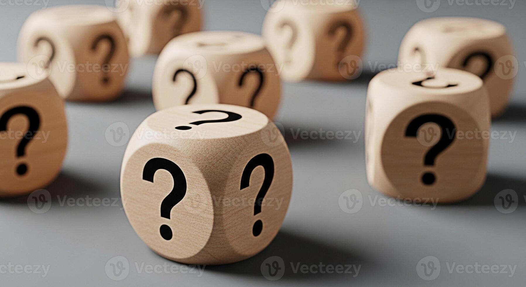 Wooden dice displaying question marks on a gray surface representing uncertainty and the search for answers in business education and personal life creating a mood of curiosity and challenge photo