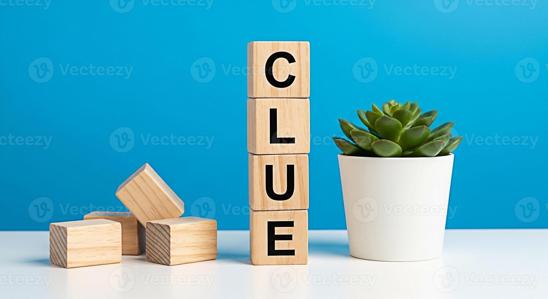 Wooden blocks spelling CLUE standing on a white table next to a succulent plant against a blue background representing problemsolving investigation and the search for answers in a bright and modern se photo