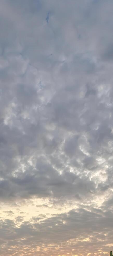 Dramatic cloudscape with golden light peeking through, perfect for adding depth and emotion to your next project, creating a serene and calming atmosphere photo