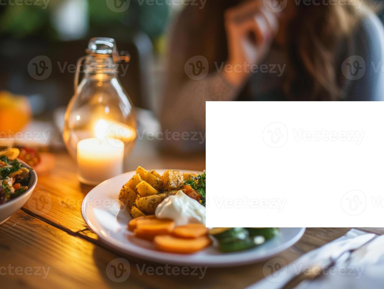 An alarm clock sits on a table beside a plate of colorful food, highlighting the concept of meal timing in intermittent fasting photo