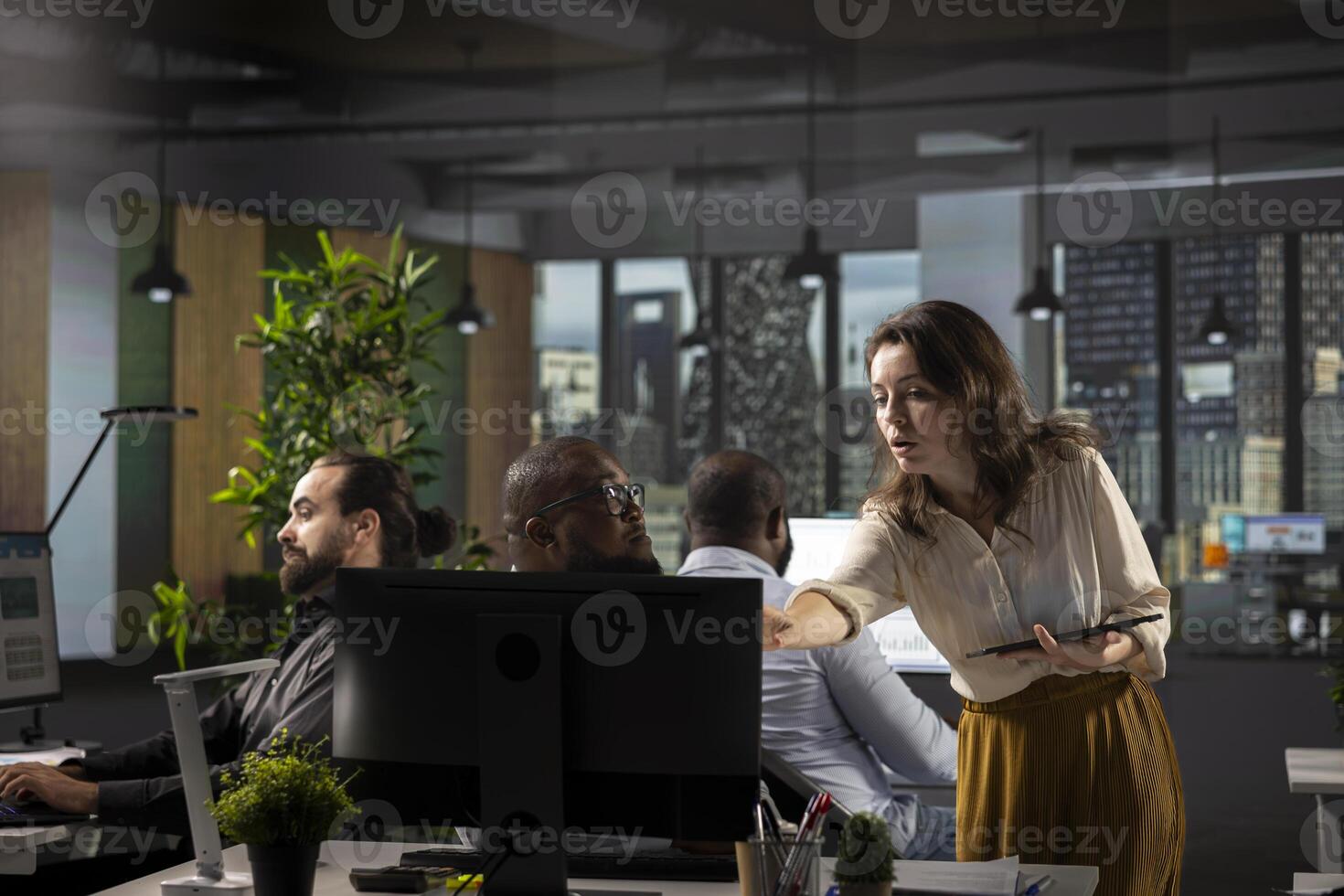 Diverse team of workers analyzing business data and performance metrics during a report sharing session in office. Staff discusses forecasting and management insights with analytics. photo