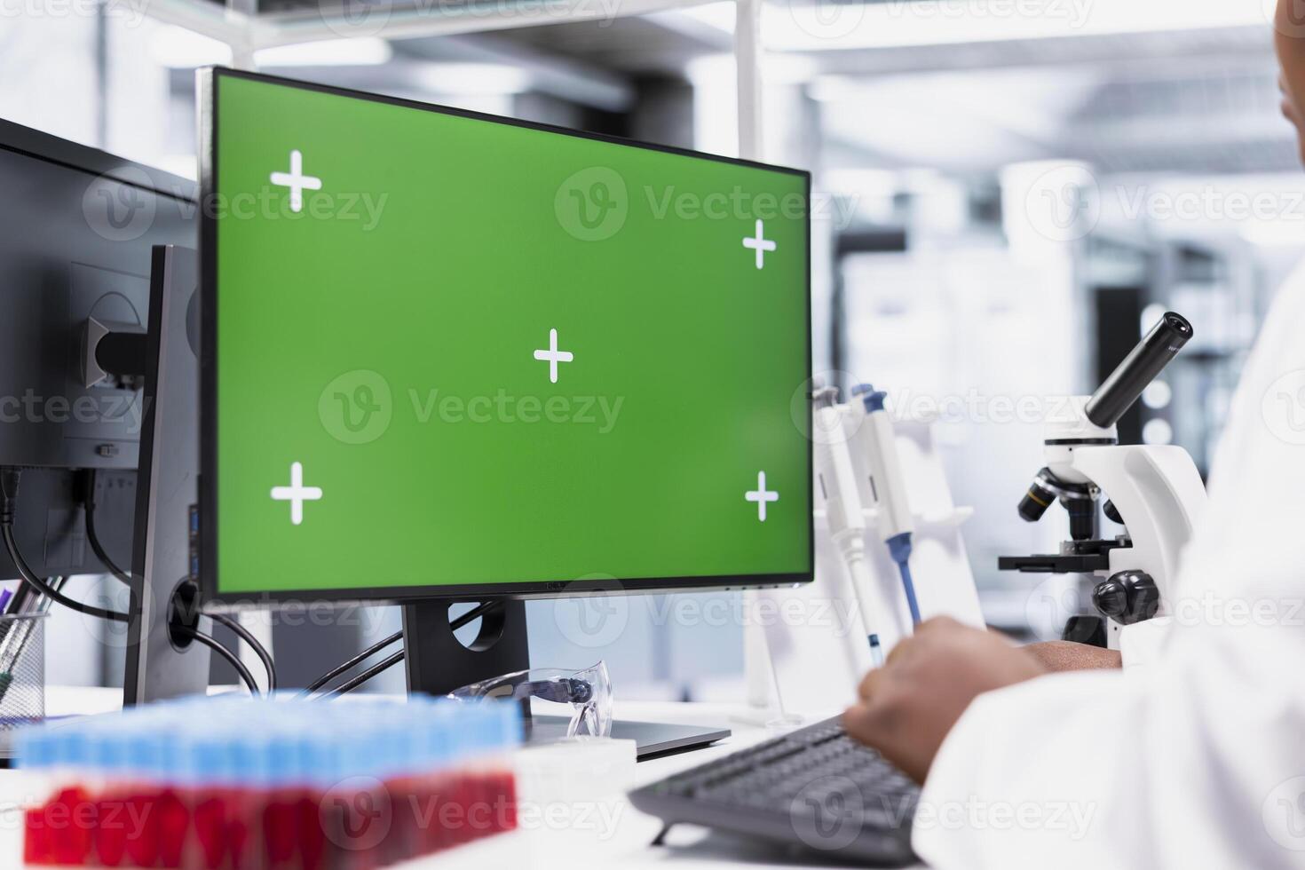 Isolated mockup screen next to scientist that works for research study, using lab equipment and biochemistry tools near desktop pc. Healthcare data analysis and genetics research for discovery. photo