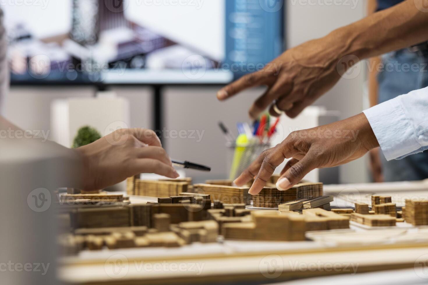 Close up of developers creating the layout for a residential project, simulating site preparation with 3D models before the construction. City planning and modern redevelopment. photo