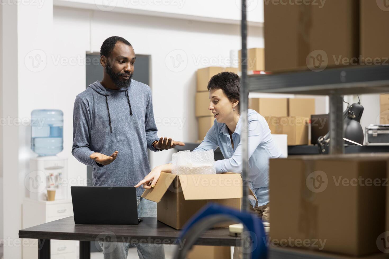 Diverse dedicated team in a fulfillment center works on shipping and distribution of goods, optimizing small business performance through efficient warehouse operations. E commerce. photo
