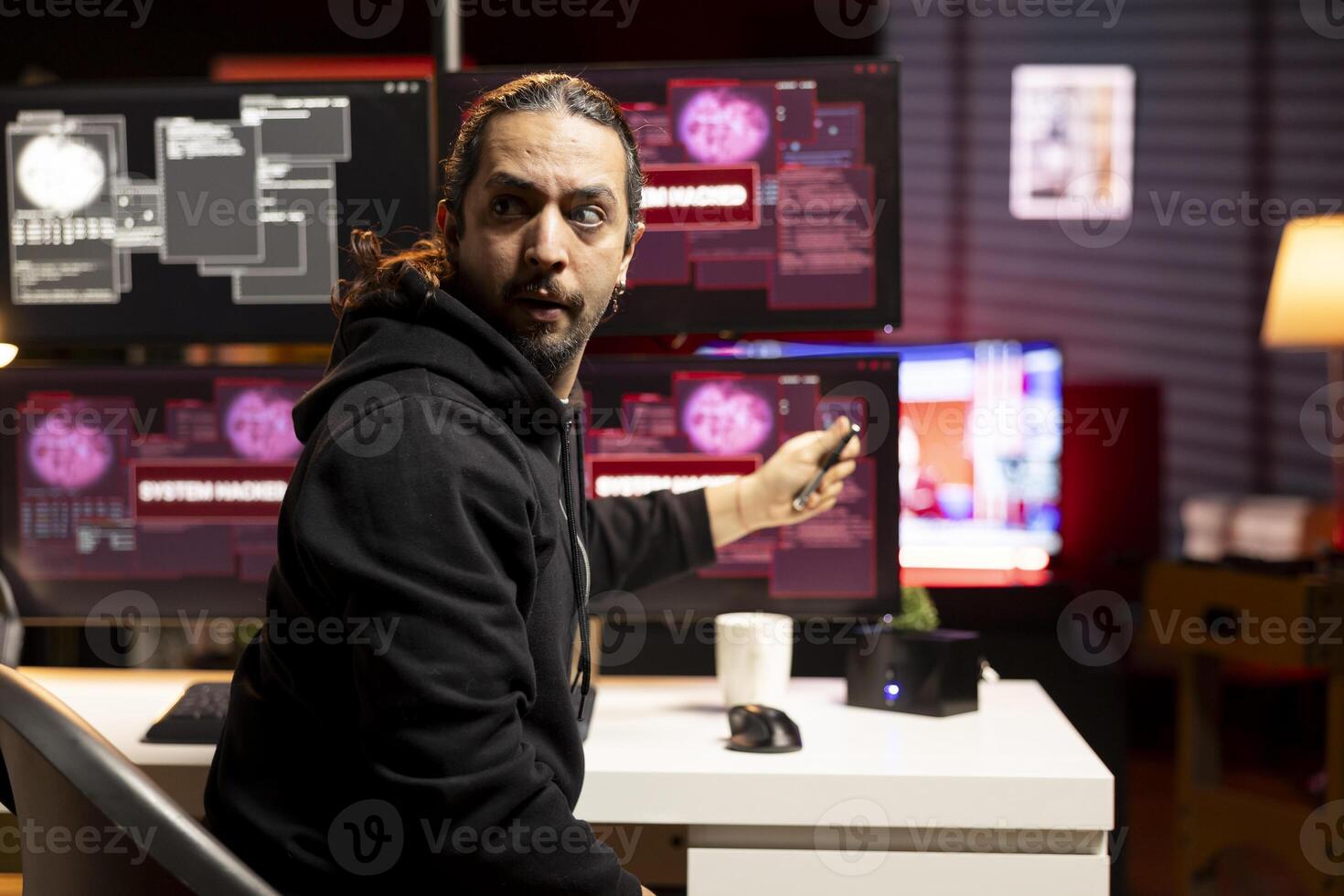 Criminal in hideout alerted by police presence after hacking into servers. Hacker found by cybercriminal law enforcement escaping with stolen data on USB after failing to conceal online identity photo