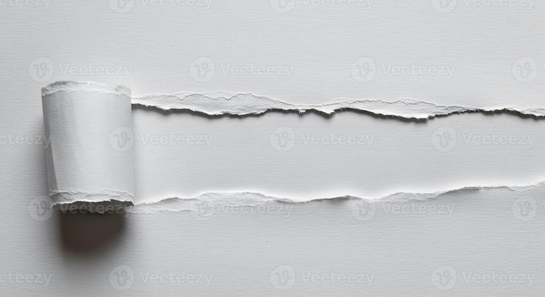 White Paper Roll with Torn Edges on Smooth Surface for Creative or Design Projects photo