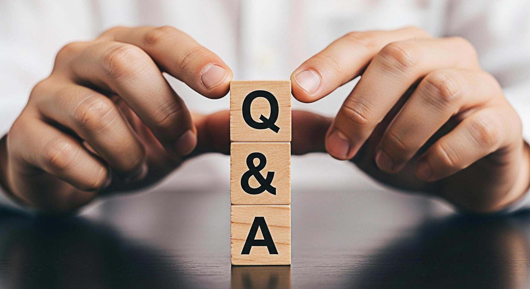 Hands arranging wooden blocks with Q A on a dark table symbolizing questions and answers problemsolving and knowledge sharing in a business context fostering clarity and understanding photo