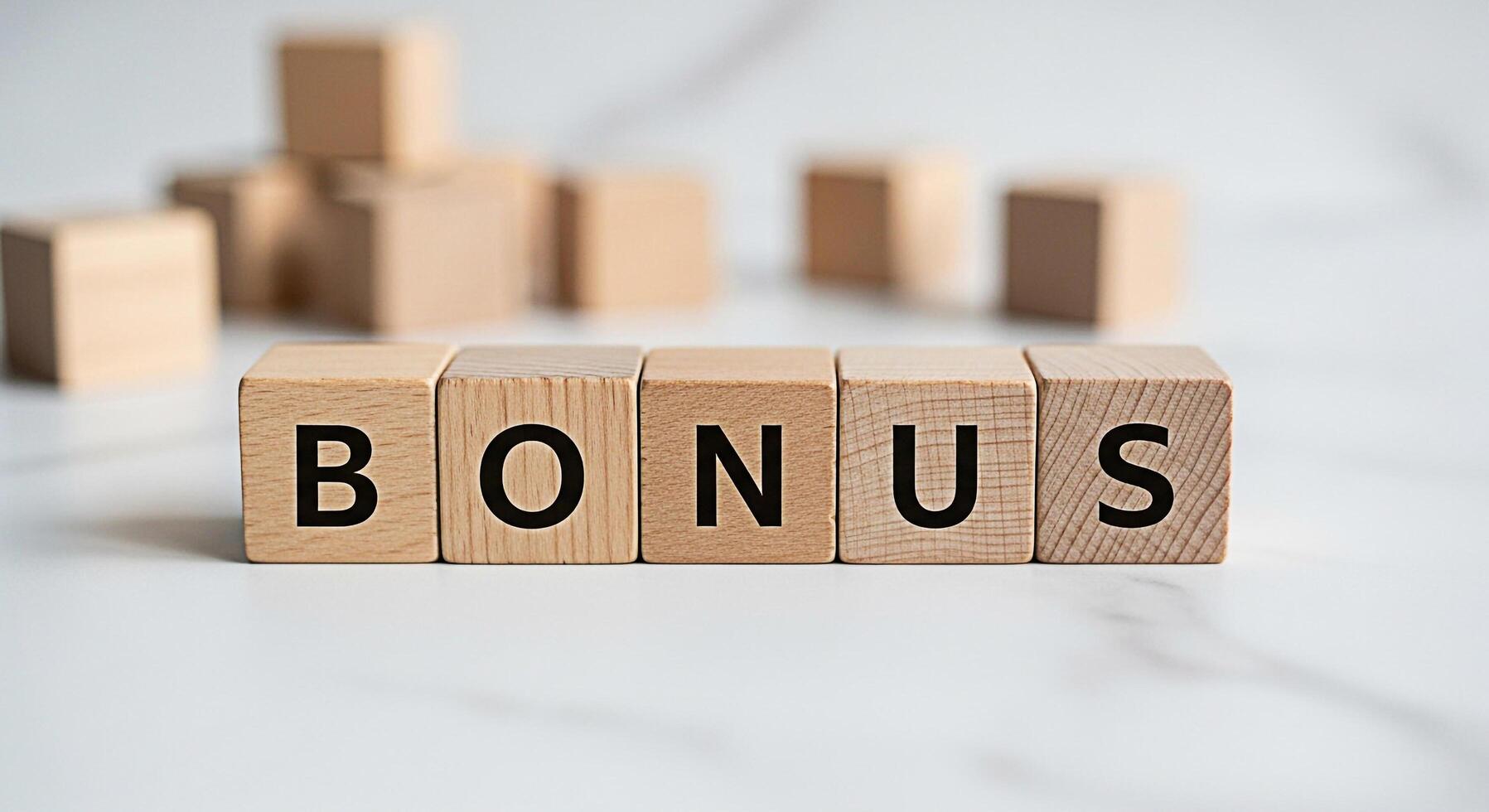 Wooden blocks spelling BONUS on a marble surface representing an incentive program financial reward or employee benefit creating a positive and motivational atmosphere in a corporate setting photo
