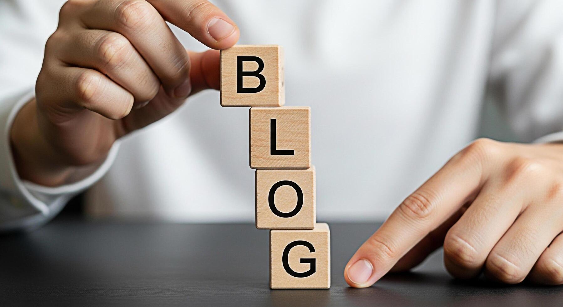 Hands arranging wooden blocks spelling BLOG on a dark table symbolizing content creation and online presence conveying a message of sharing ideas and building a community through blogging photo