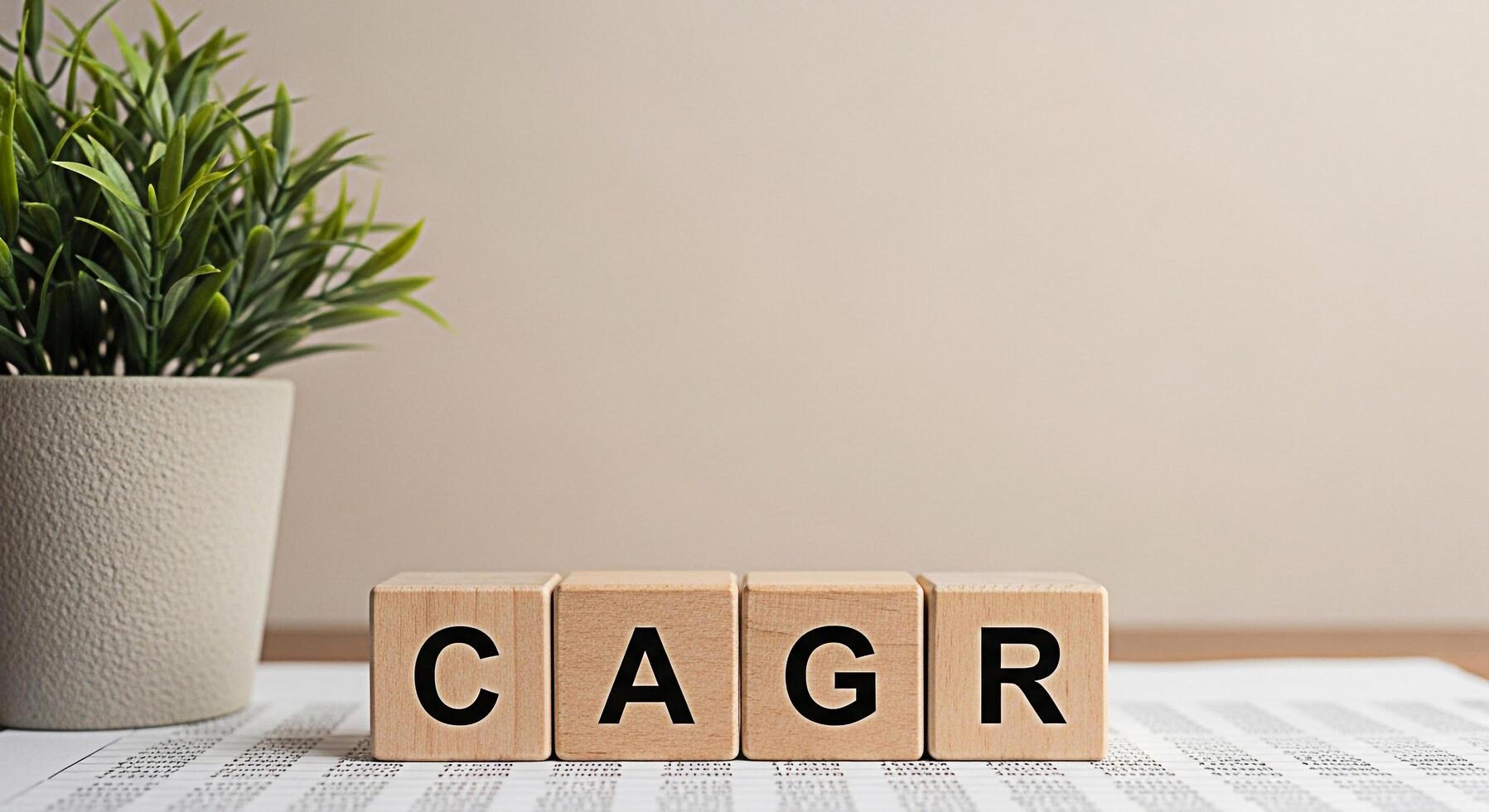 Wooden blocks spelling CAGR resting on financial data in a bright office symbolizing compound annual growth rate and investment success creating a sense of financial security and growth potential photo