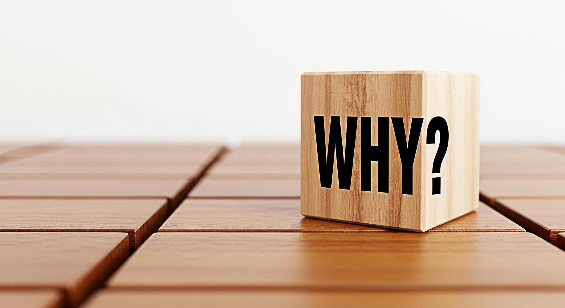 Wooden cube displaying WHY on a wooden surface prompting reflection and inquiry in a minimalist setting encouraging curiosity and problemsolving fostering a thoughtful and questioning mindset photo