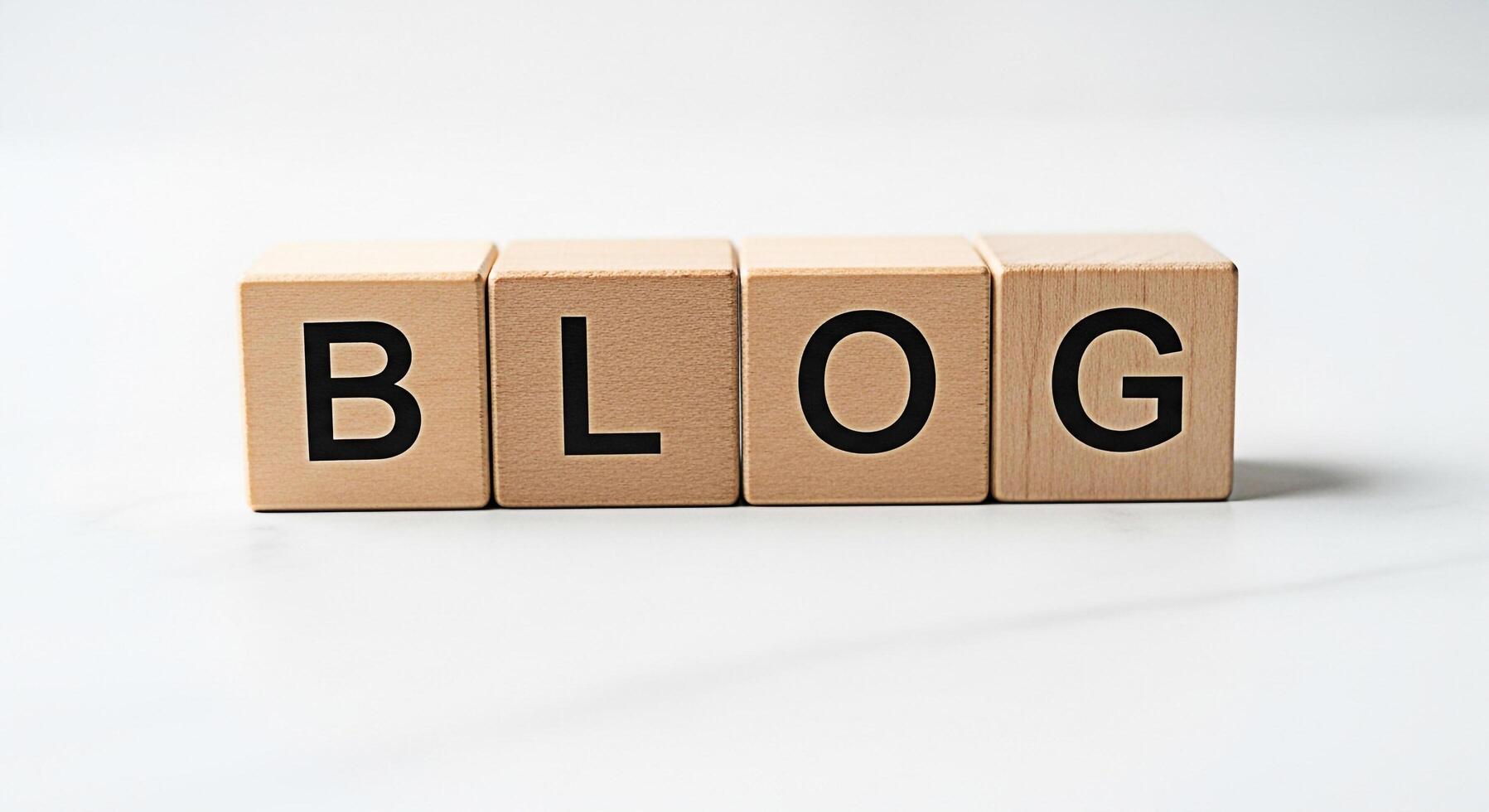 Wooden blocks spelling BLOG on a clean white surface representing online content creation and sharing conveying a message of information connection and digital communication in a minimalist setting photo