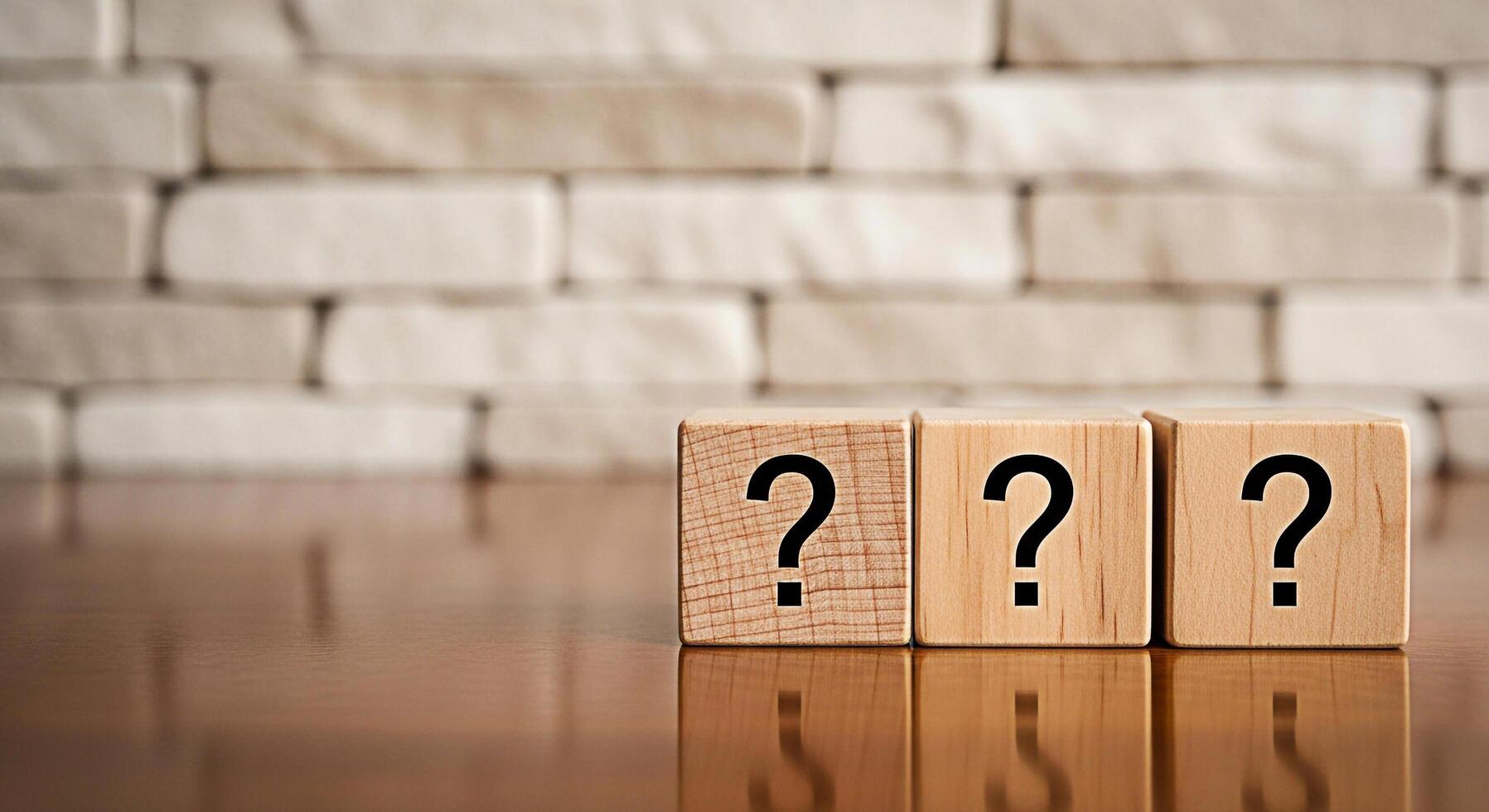 Three wooden blocks displaying question marks sit on a reflective wooden surface against a blurred brick wall representing uncertainty inquiry and the search for answers in a conceptual setting photo