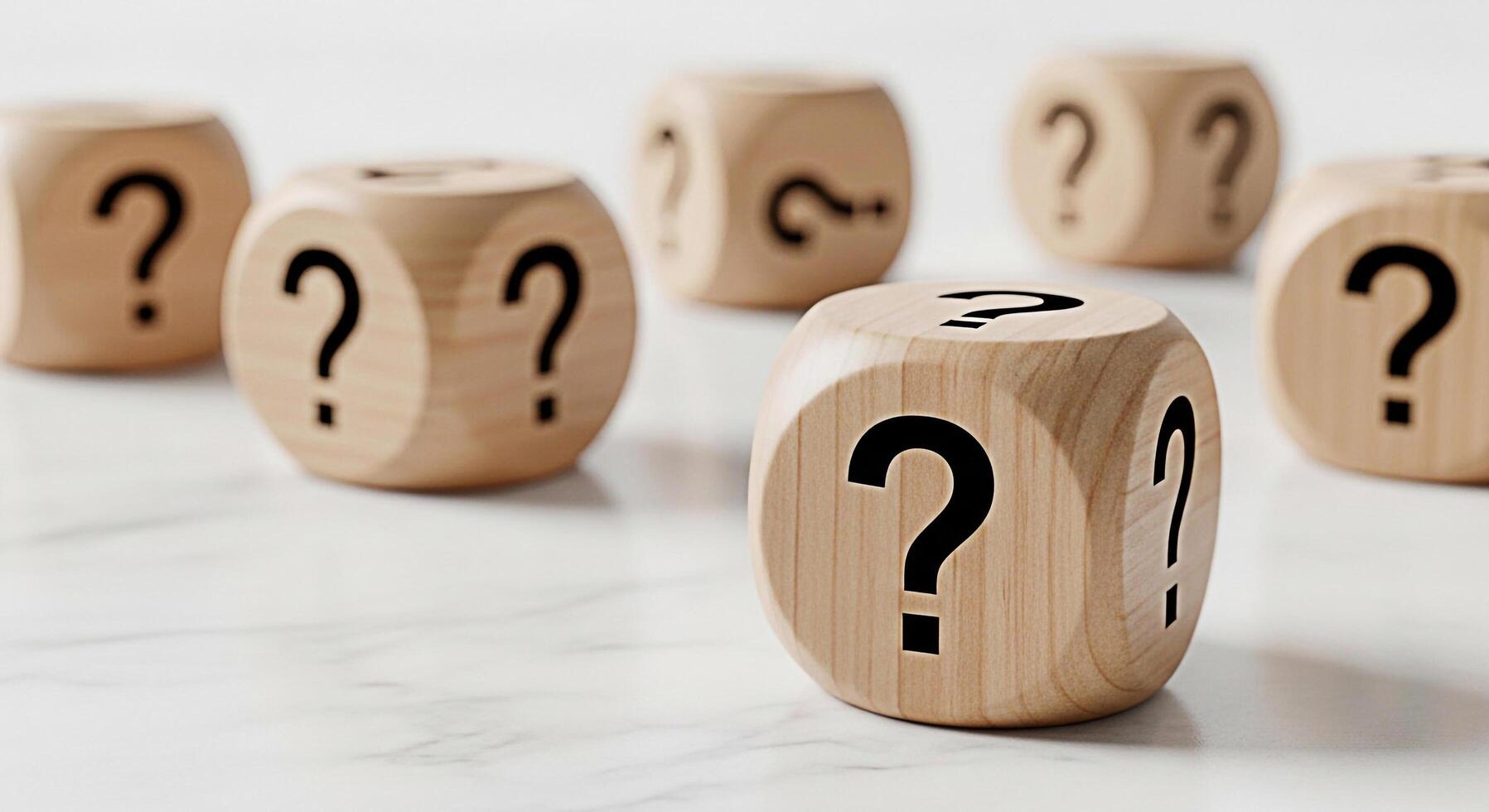 Wooden dice displaying question marks on a white marble surface representing uncertainty and the need for answers creating a sense of curiosity and problemsolving in a bright studio setting photo