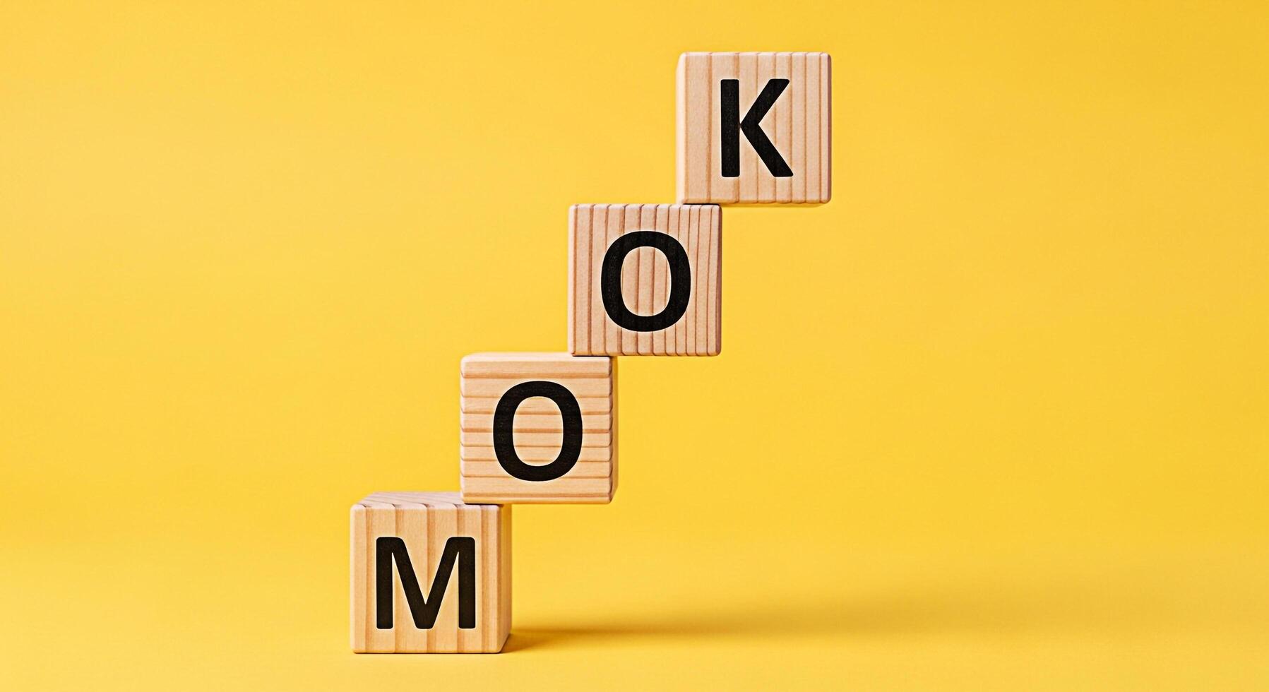 Wooden blocks spelling Mook stacked on a vibrant yellow background symbolizing learning and growth creating a playful and educational atmosphere with a focus on early childhood development and languag photo
