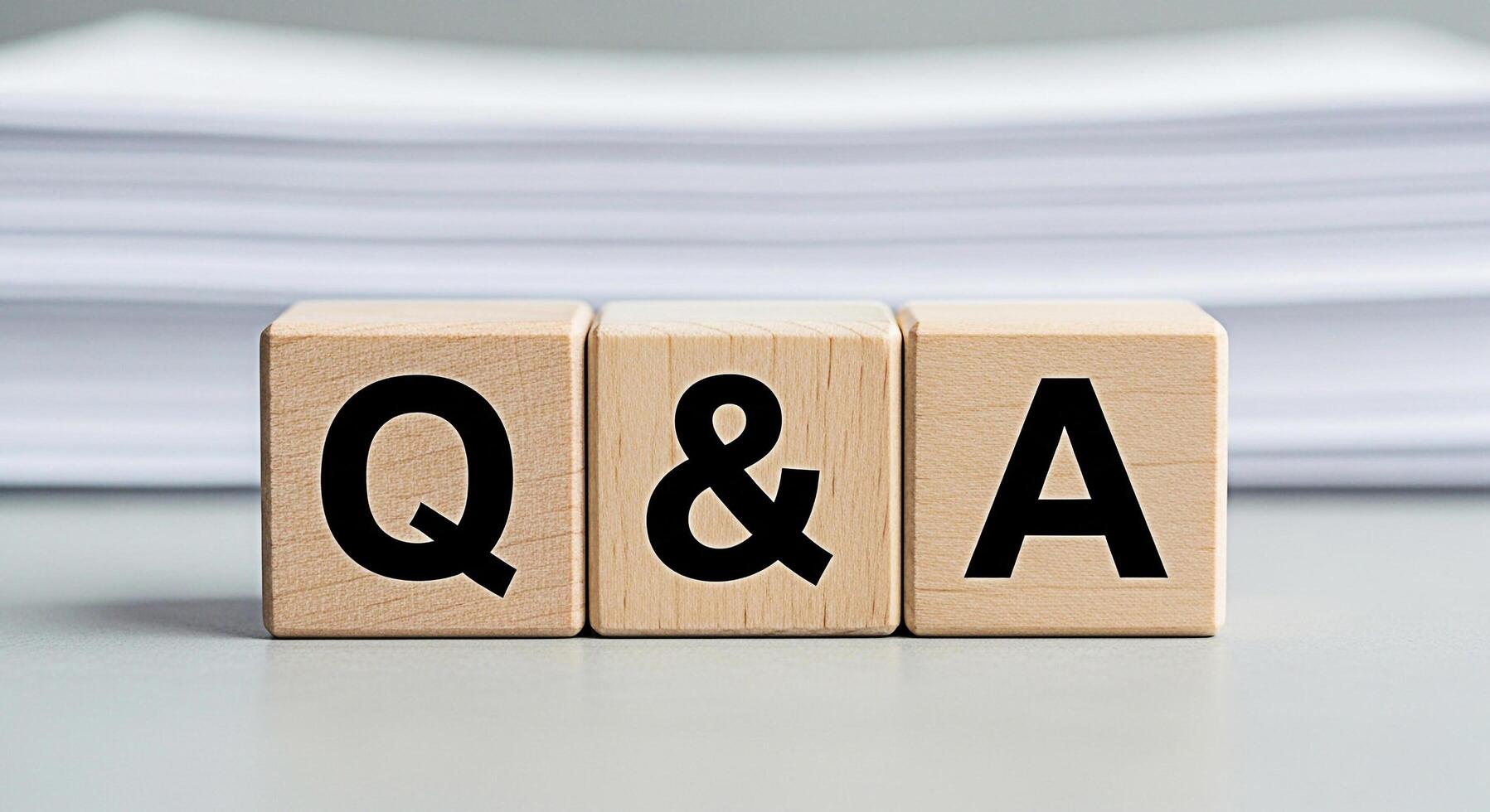 Wooden blocks displaying QA on a table symbolizing questions and answers in a business environment creating a clear and concise message for information and knowledge sharing photo