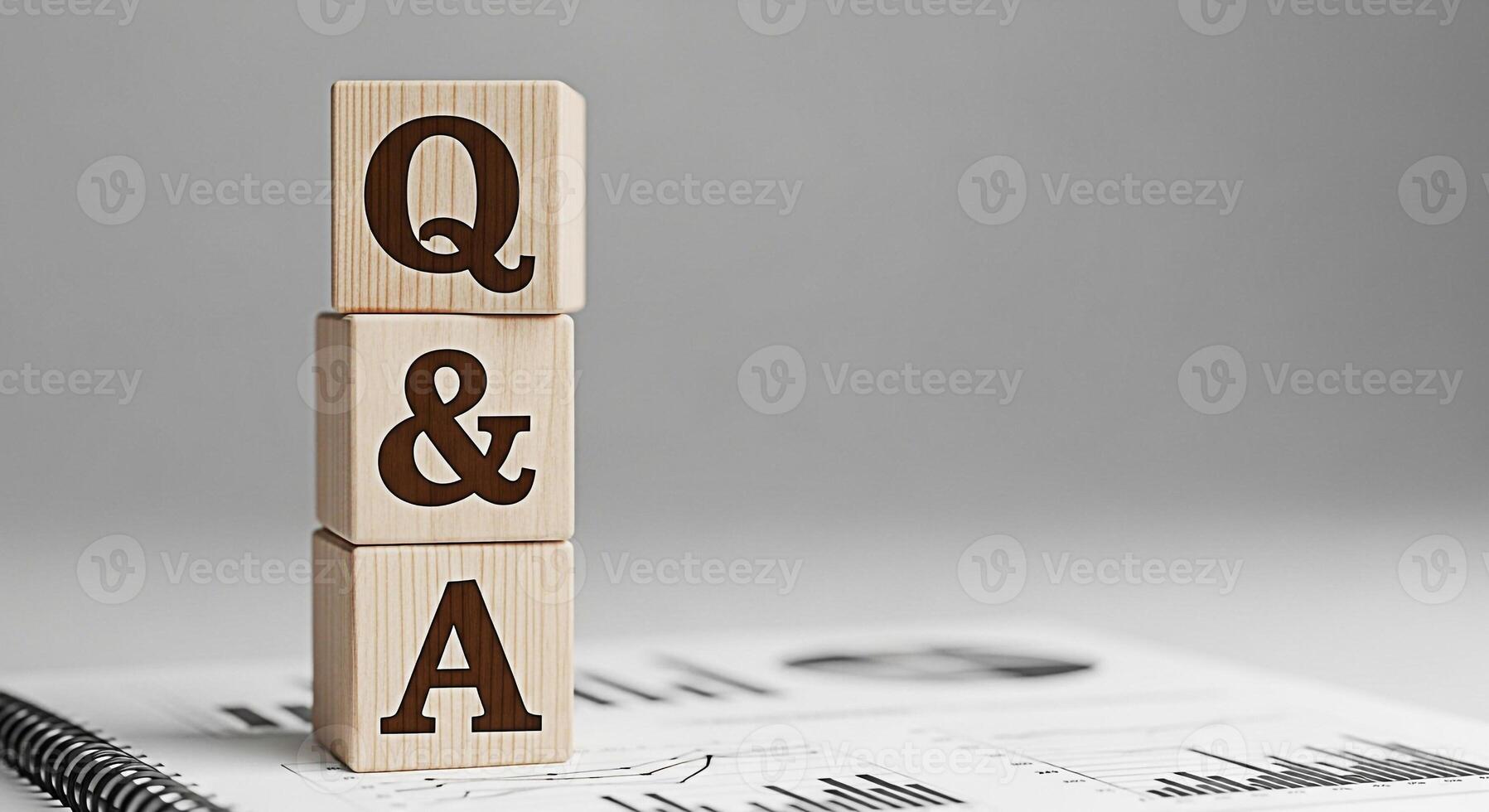 Wooden blocks displaying QA stacked on a financial report in a bright studio setting representing knowledge sharing problemsolving and informed decisionmaking for business growth and success photo
