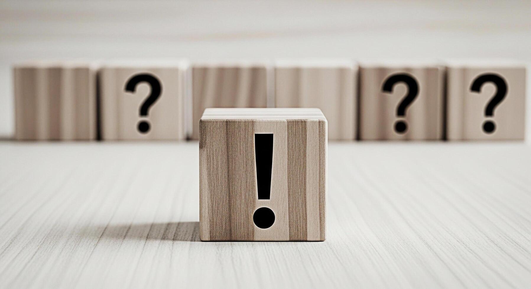Wooden block displaying an exclamation mark stands out among question mark blocks on a bright surface symbolizing clarity solutions and decisive action in problemsolving and decisionmaking processes photo
