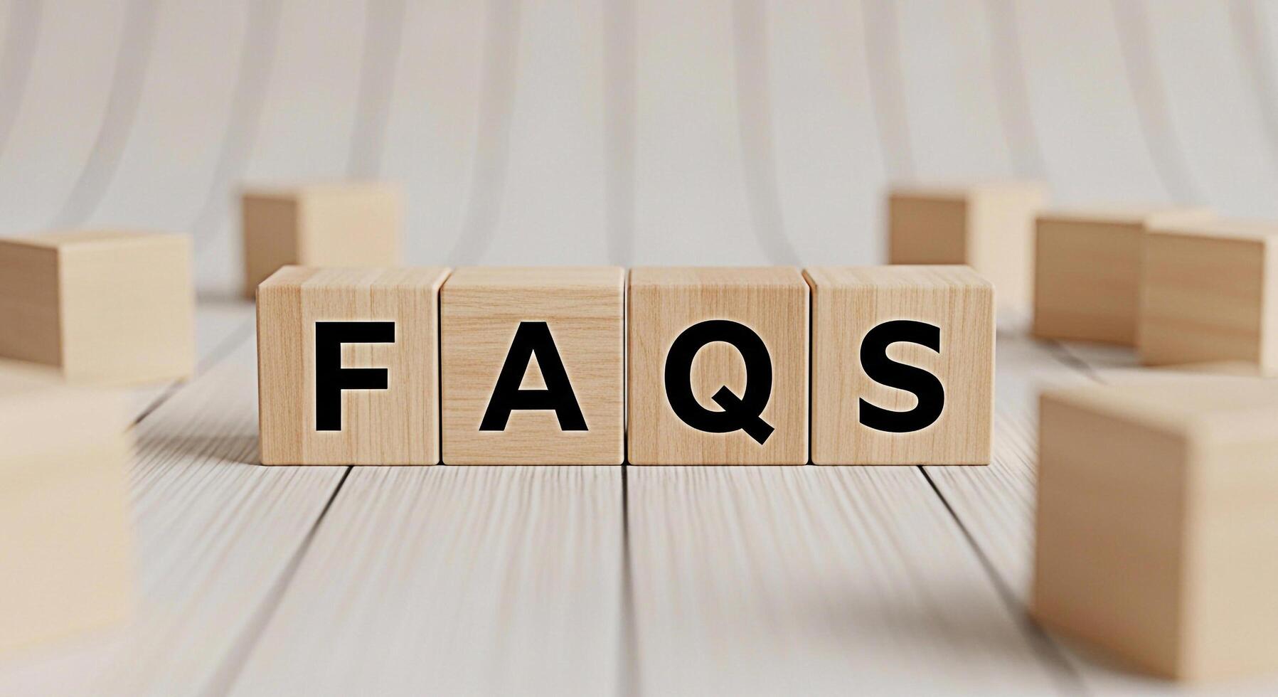 Wooden blocks spelling FAQs on a white wooden surface representing answers to common queries and providing information creating a helpful and informative atmosphere for viewers photo