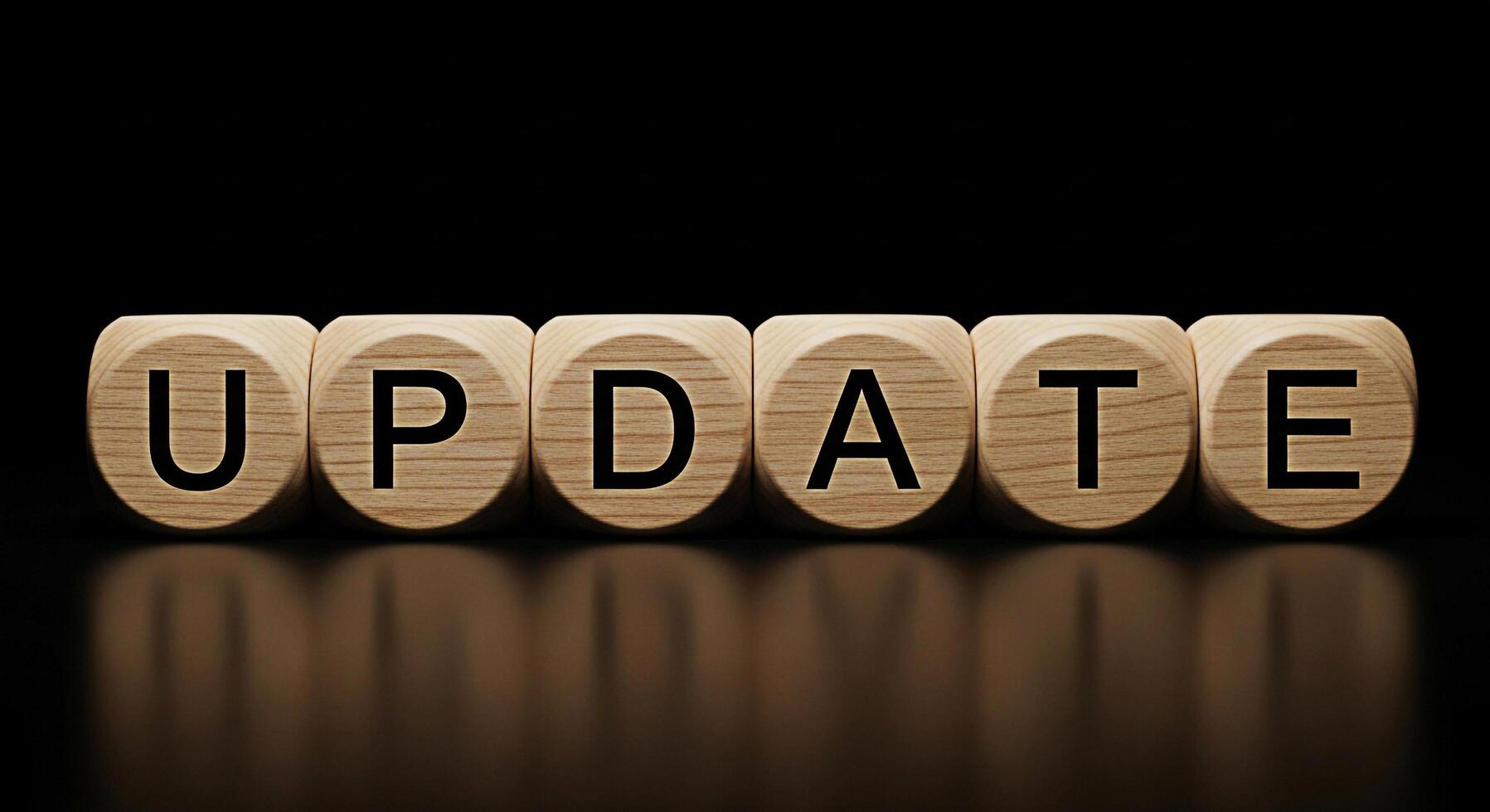 Wooden blocks spelling UPDATE in a dark environment symbolizing progress and improvement highlighting the importance of staying current and relevant in a dynamic world conveying a sense of advancement photo