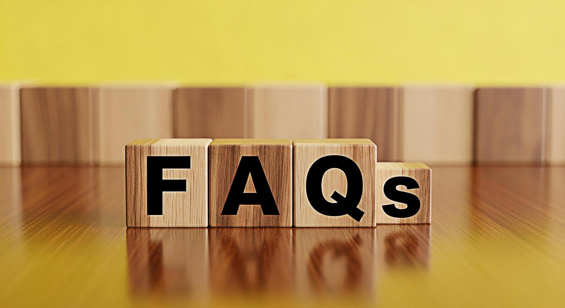 Wooden blocks spelling FAQs on a shiny wooden surface against a yellow background representing frequently asked questions and providing information creating a helpful and informative atmosphere photo