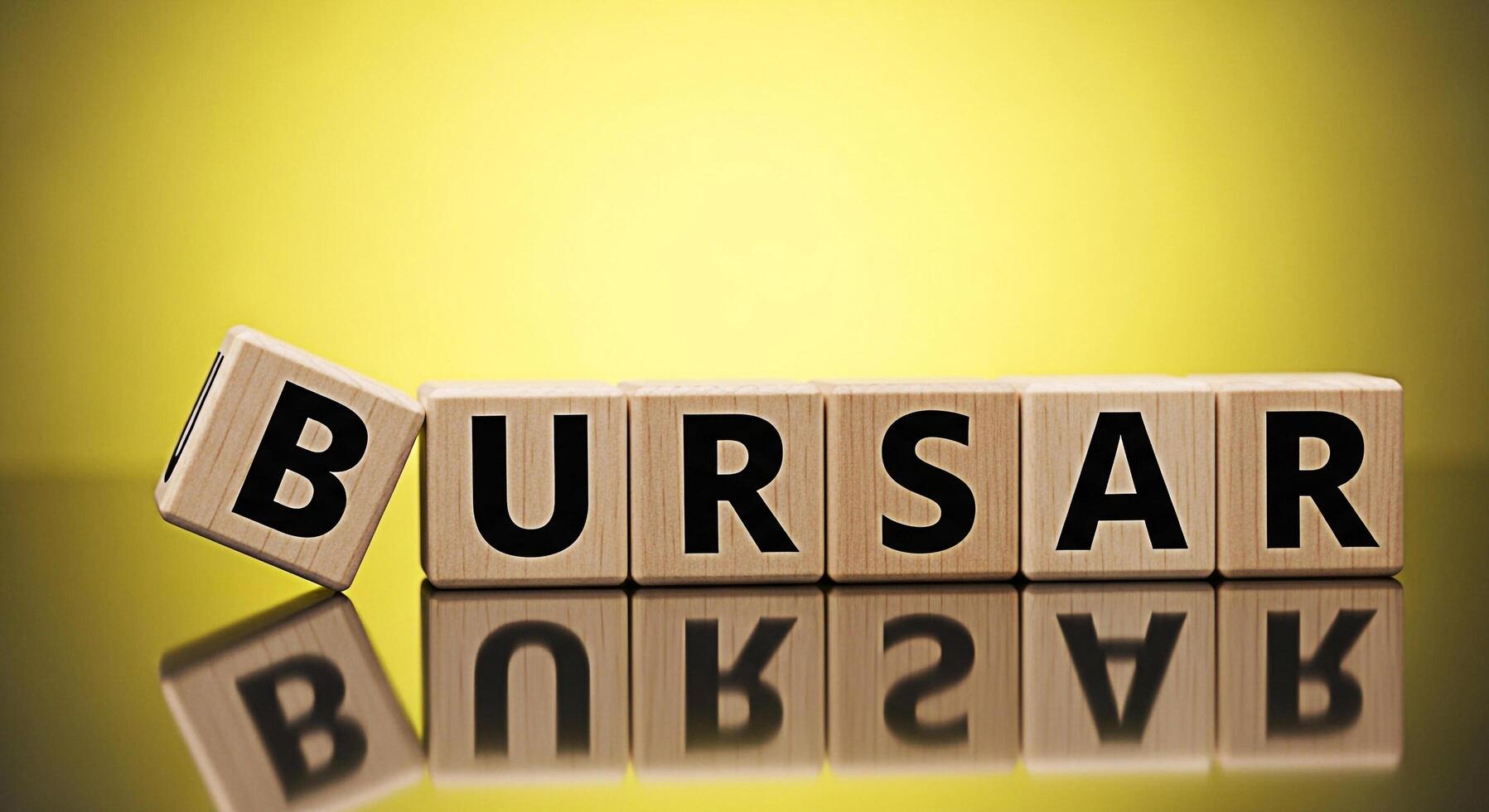 Wooden blocks spelling BURSAR on a reflective surface against a yellow backdrop symbolizing financial management and the role of a bursar in handling money matters with precision and responsibility photo