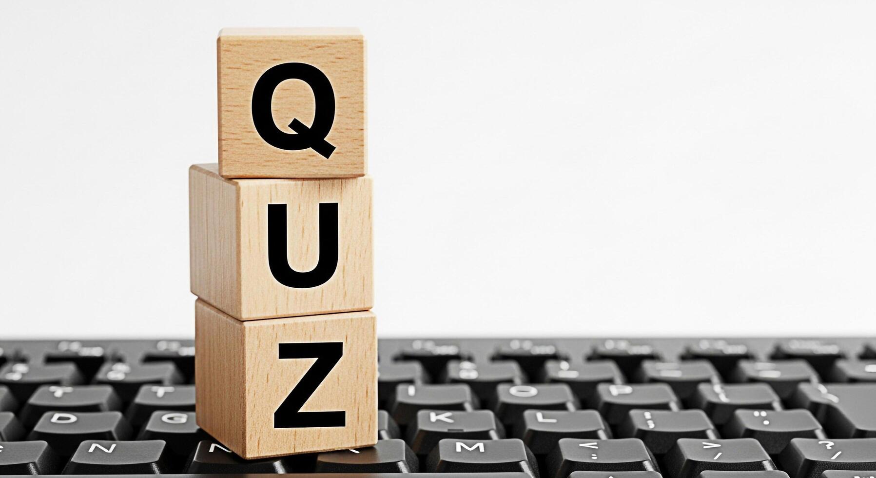 Wooden blocks spelling QUIZ stacked on a black computer keyboard against a white background representing knowledge testing online learning and interactive education in a digital environment photo