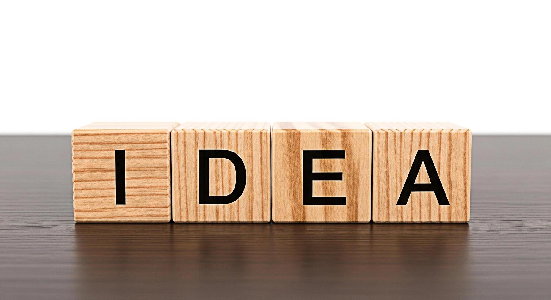 Wooden blocks spelling IDEA sitting on a dark wooden table representing creativity and innovation in a bright minimalist setting symbolizing brainstorming and problemsolving with a positive and inspir photo