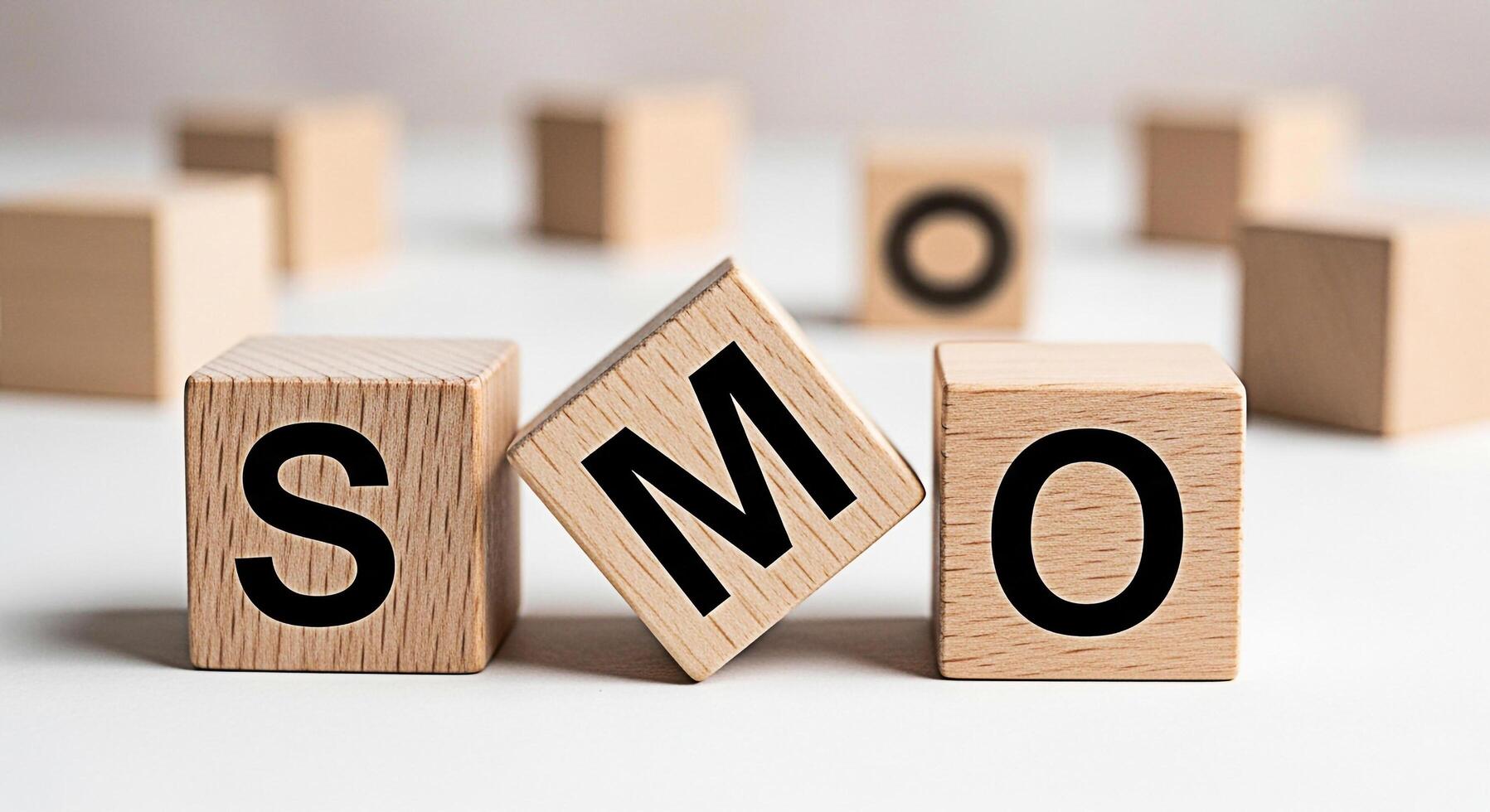 Wooden blocks displaying SMO on a white surface representing social media optimization conveying a message of marketing strategy and digital presence in a clean and minimalist environment photo