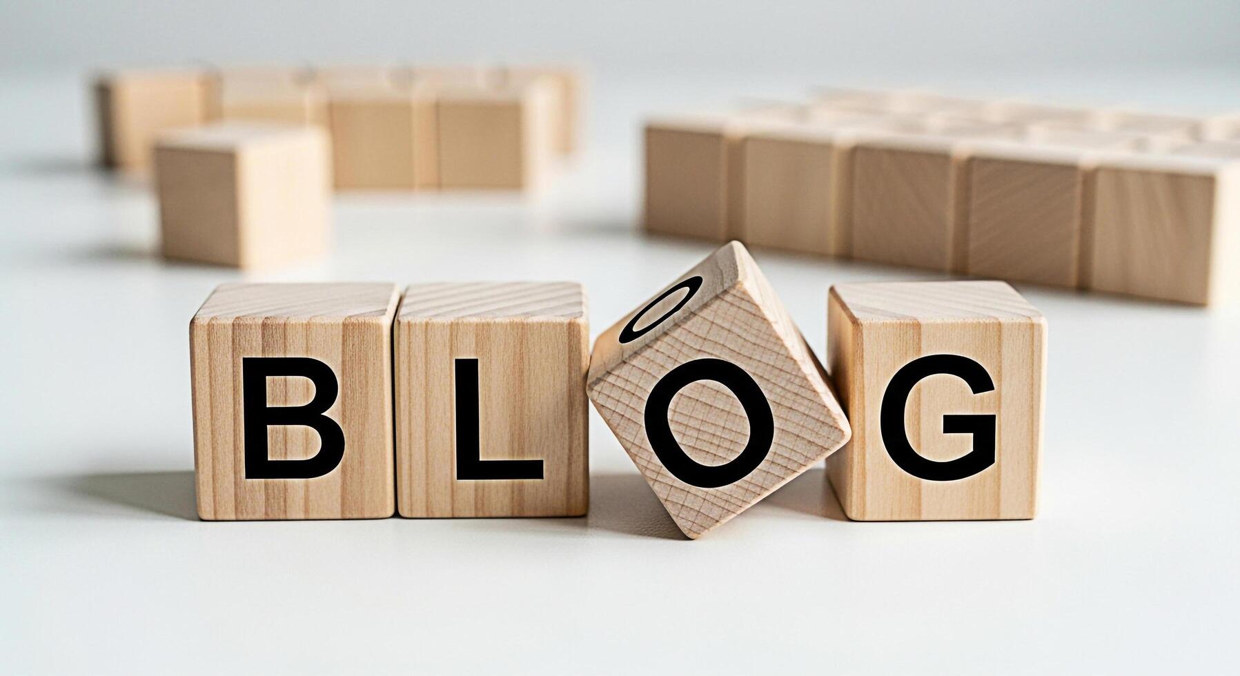 Wooden blocks spelling out BLOG on a white surface conveying a message about online content creation sharing ideas and building a community through blogging in a clean minimalist setting photo